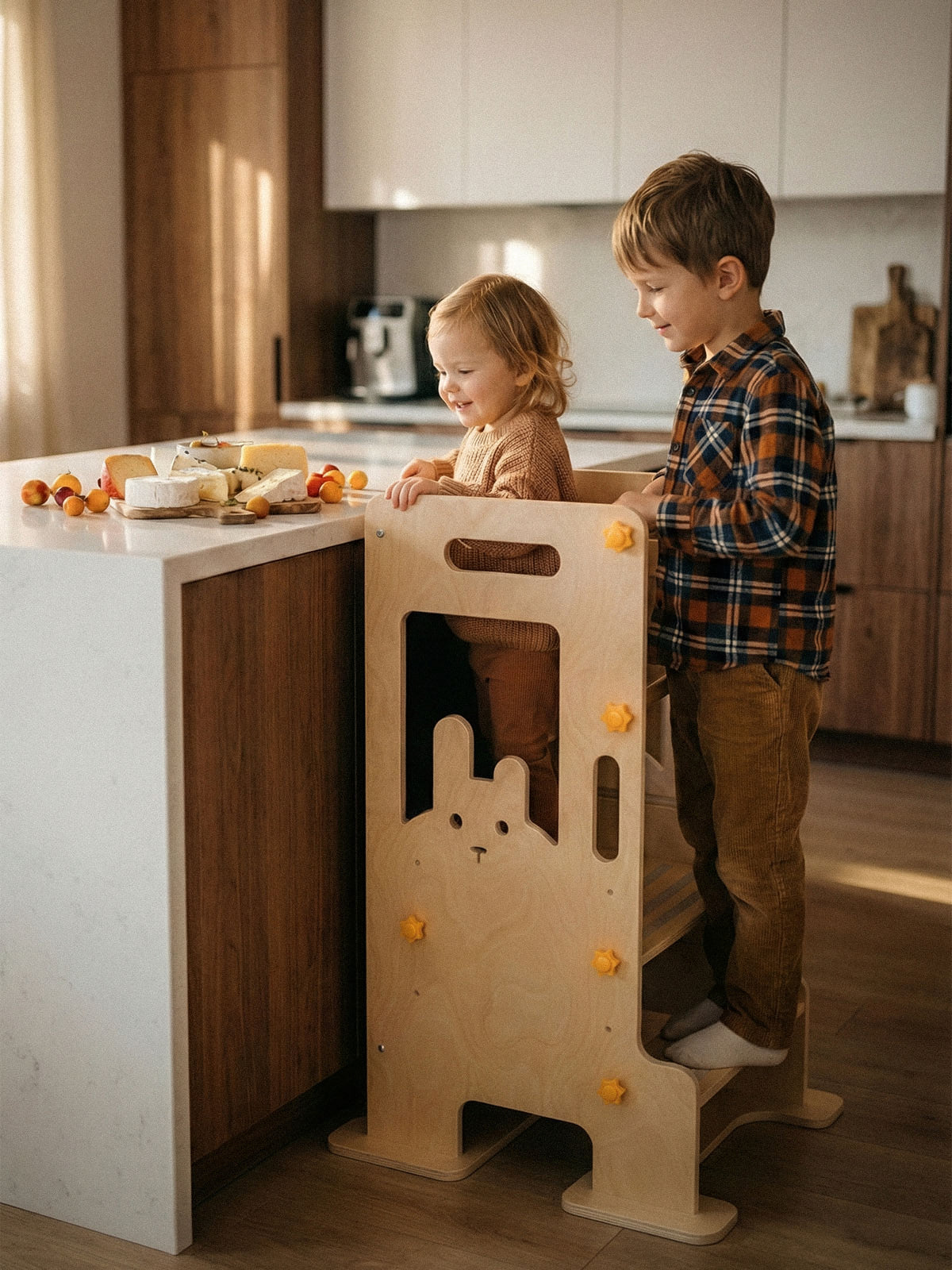 Two toddlers use the HICOOO learning tower and toddler tower to reach the kitchen counter, essential kitchen aids in Montessori furniture and great helpers for home learning.