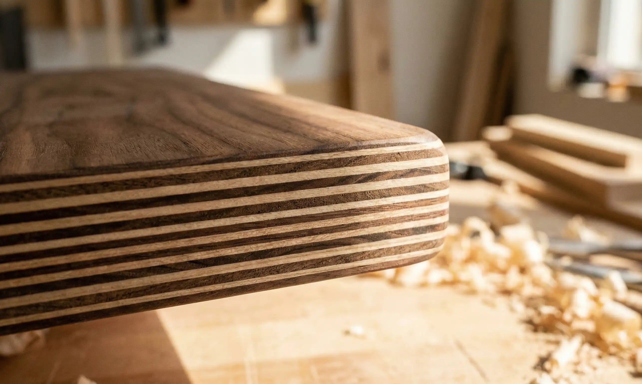 Macro shot of a 9-ply birch plywood edge, clearly showing the precise cross-laminated layers and smooth finish that ensure durability in high-quality furniture.