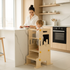 Toddler using kitchen helper stool to wash vegetables