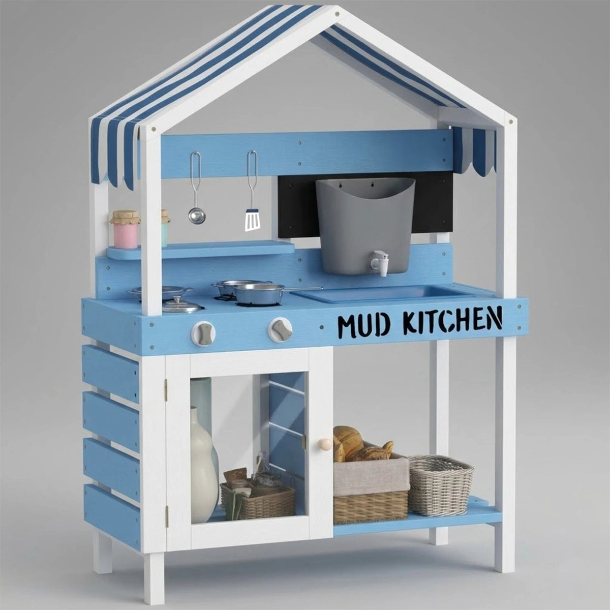 A studio shot of a wooden kids mud kitchen painted in light blue and white, featuring a charming striped canopy roof. The play set includes a pretend stovetop with toy pots, a sink basin, a functional-looking grey water dispenser with a tap, hanging utensils, and a small chalkboard. The text "MUD KITCHEN" is boldly printed on the front counter. The lower section features a white storage cabinet with a clear window door and open shelving holding woven baskets, set against a plain light gray background.