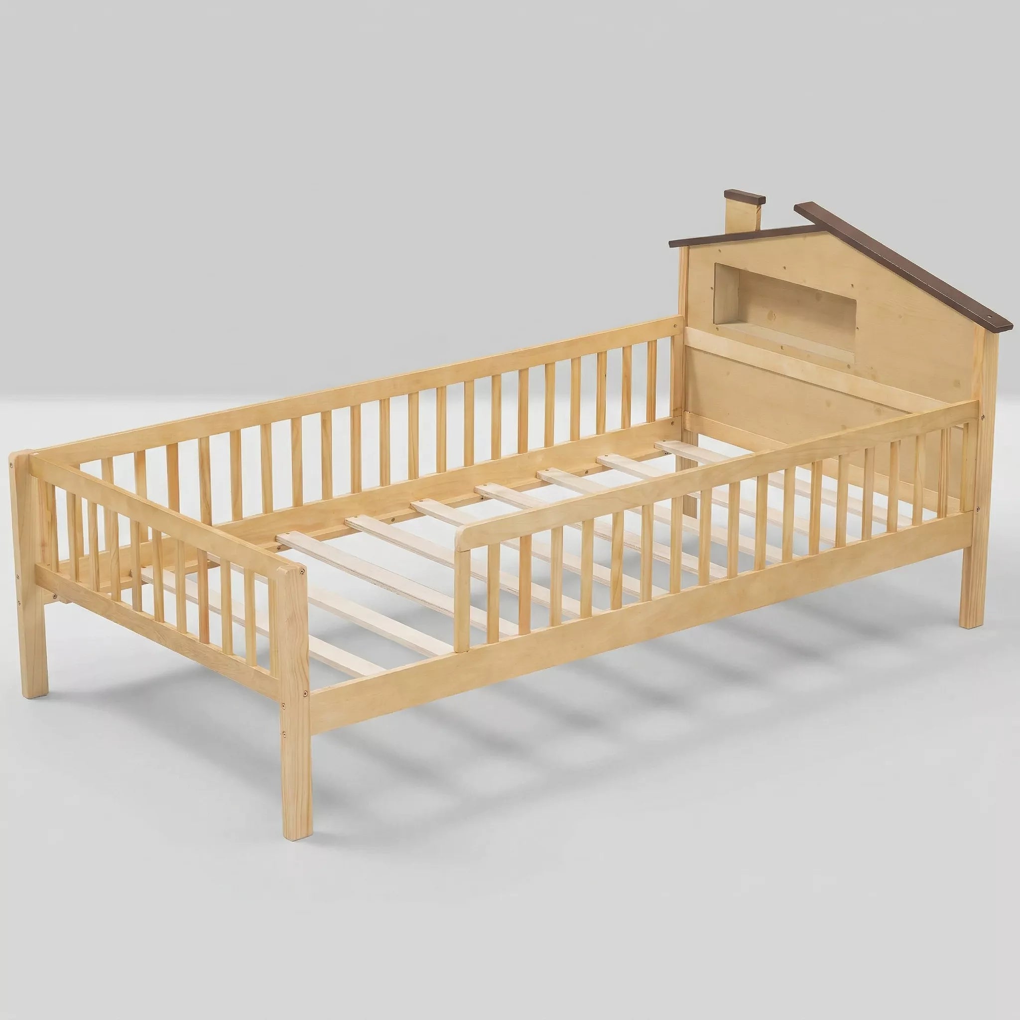 A detailed close-up photograph focusing on the unique house-shaped headboard of a twin size kids bed. It features a natural wood base, white painted panels forming a stylized house with a roofline and chimney, and a square window cut-out with an integrated ledge for storage.