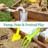  Close-up of elevated wooden sandbox water pump feature with yellow shovel and green rake accessories for toddler sand and water play