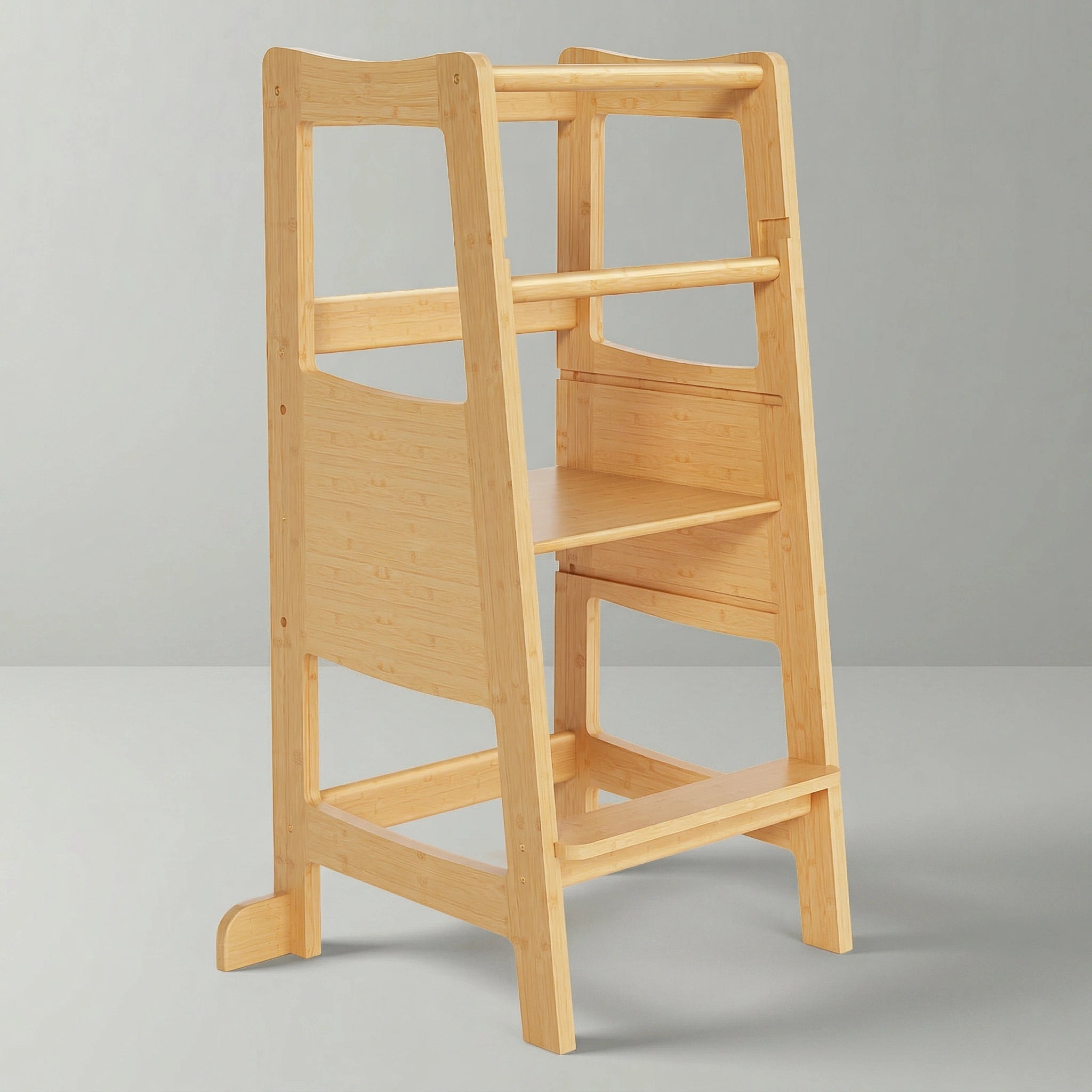 A sturdy natural bamboo Montessori toddler learning tower featuring safety rails and anti-slip feet on a clean background.