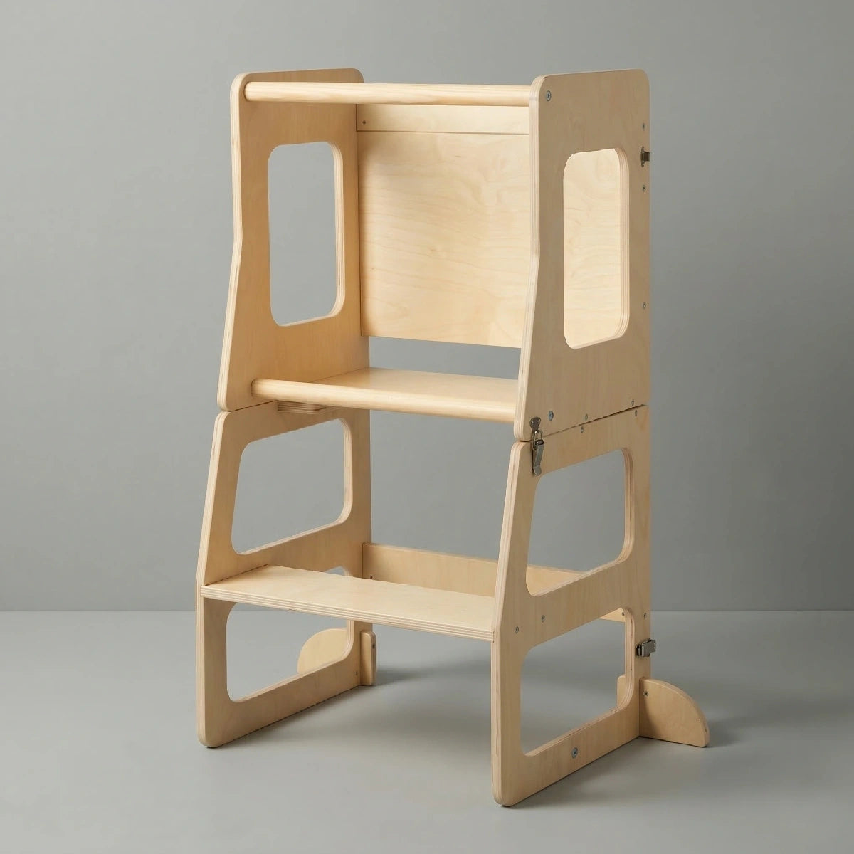 The Hicooo natural wood foldable toddler tower standing upright on a light grey background, showing its sturdy base, safety rails, and two step levels for young children.