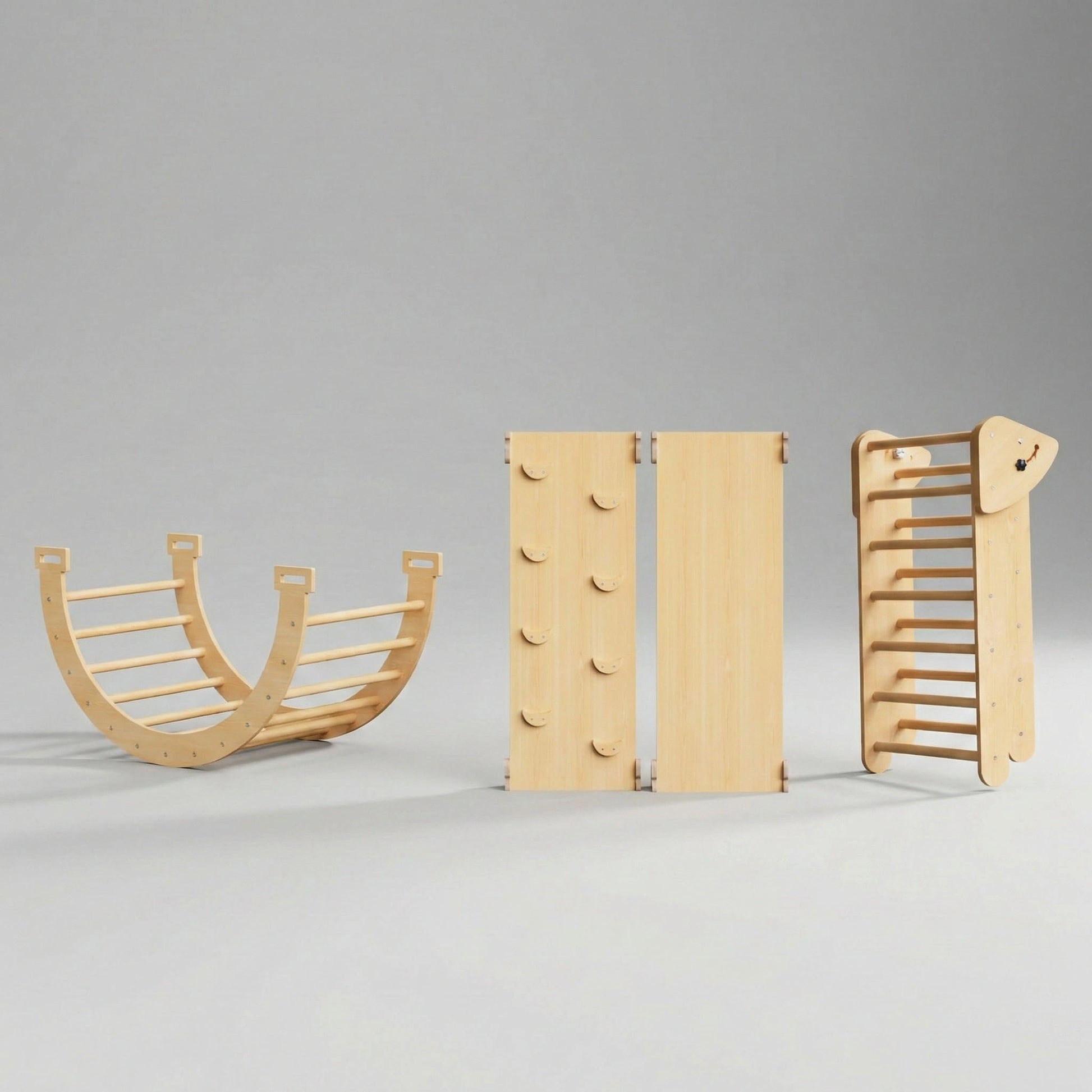 Studio shot showing the components of a Hicooo Montessori climbing set. From left to right: a wooden arch used as a rocker, a reversible ramp displaying both the slide and climbing hold sides, and a folded Pikler triangle for compact storage.