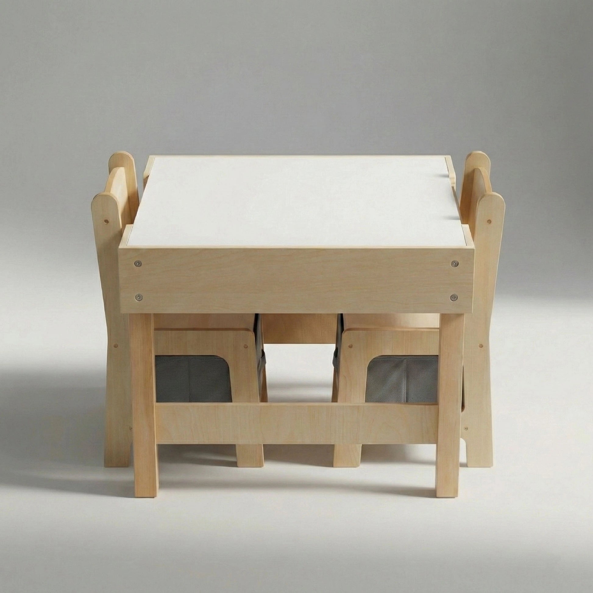 Studio shot of the Hicooo space-saving kids table and chair set. Shows the wooden chairs tucked neatly underneath the table to demonstrate its compact footprint, highlighting the grey fabric storage bins under the seats.