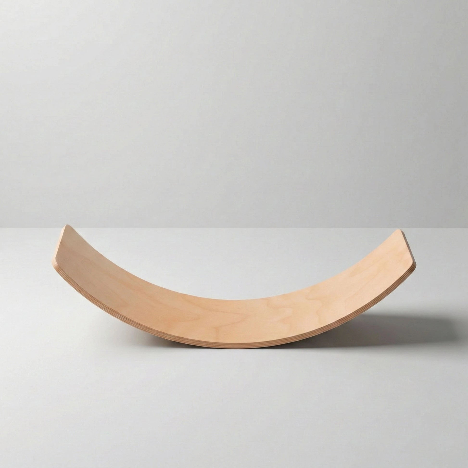 Side profile studio shot of Hicooo wooden balance board. Clearly displays the symmetrical U-shaped curve and the durable layered wood construction against a white background.