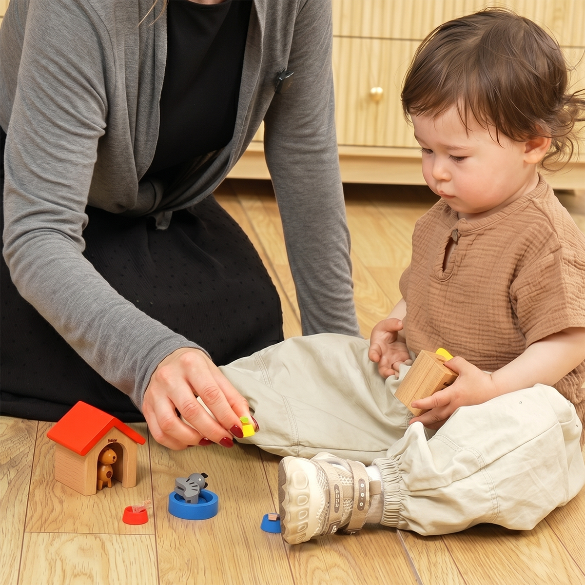 Mother guiding baby toddler to explore Hicooo wooden pet toy set with dog kennel and cat figure on hardwood floor