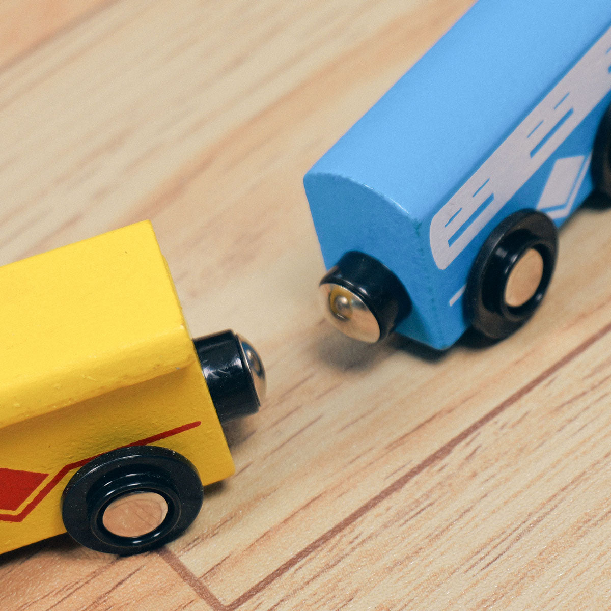 Blue and yellow wooden train cars on track product detail close-up
