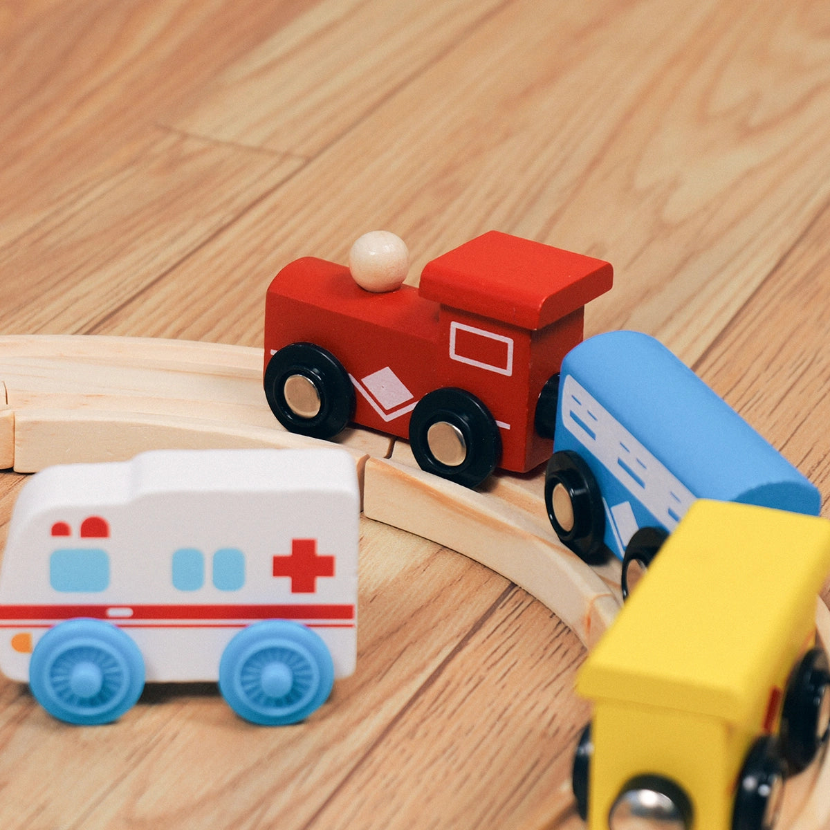 Wooden train car set including ambulance and yellow freight car product shot