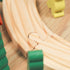 Wooden curved train track with green cargo car close-up, beechwood material detail