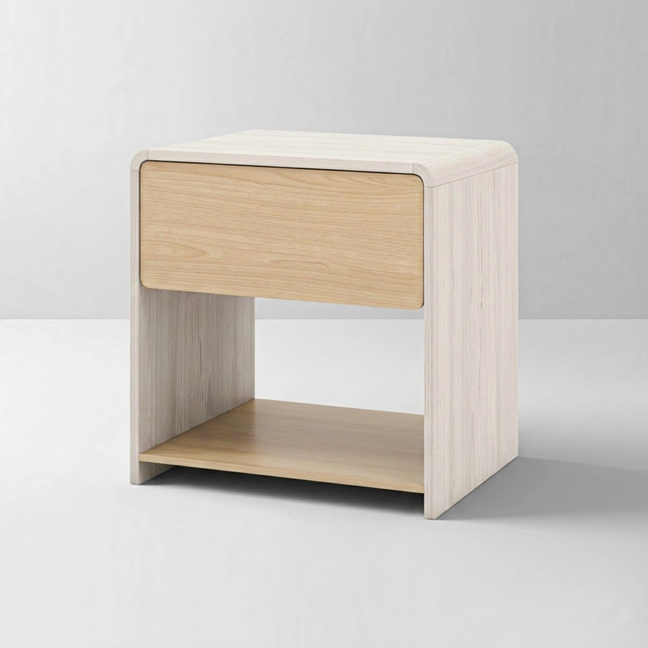 A studio shot of a modern light wood nightstand against a clean white background. It clearly displays the contemporary two-tone wood design, child-safe rounded edges, a smooth upper drawer with a hidden handle, and an open lower storage shelf.