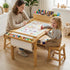 Lifestyle image of a mother and a toddler girl sitting on stools at the Hicooo wooden art table. They are drawing together on the continuous paper roll, showcasing the spacious tabletop and collaborative design suitable for parent-child bonding.