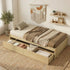 A lifestyle photograph capturing a white-painted wooden twin-size platform bed frame set up in a cozy, naturally lit bedroom with light hardwood floors. The bed features a mattress, a simple grey and white bedding set, a low headboard, and is positioned near a minimalist wooden nightstand with a lamp and a wall mirror.