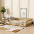 Wooden crib in a room with a plant, rug, and wall art