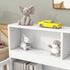 White shelf with toys including a gray elephant, yellow car, and white dog on a light green wall background.