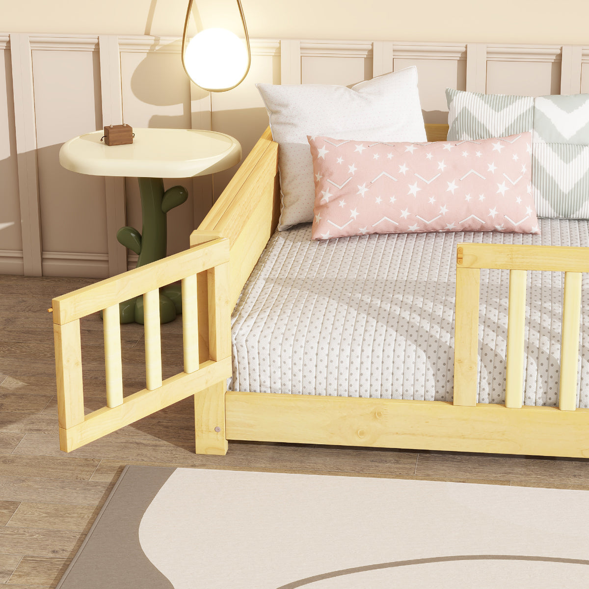 Wooden crib with white bedding and pink pillow in a bedroom setting