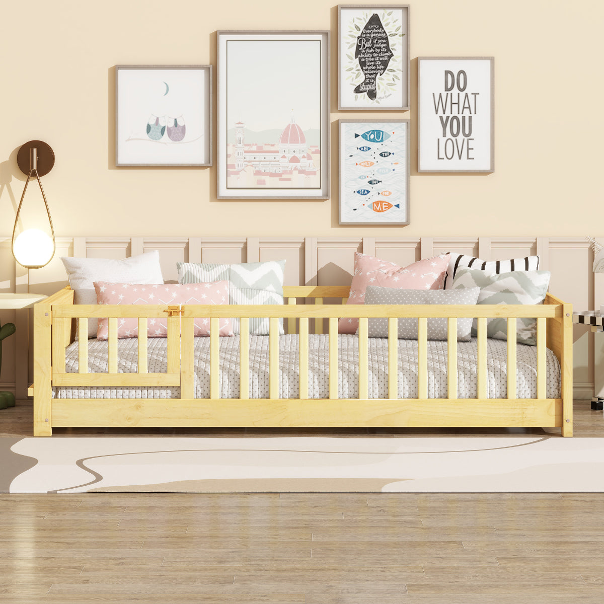 Children's bed with a wooden frame in a room with framed pictures on the wall.