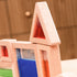 Close-up of wooden sensory blocks filled with vibrant blue and green translucent liquids reflecting light.