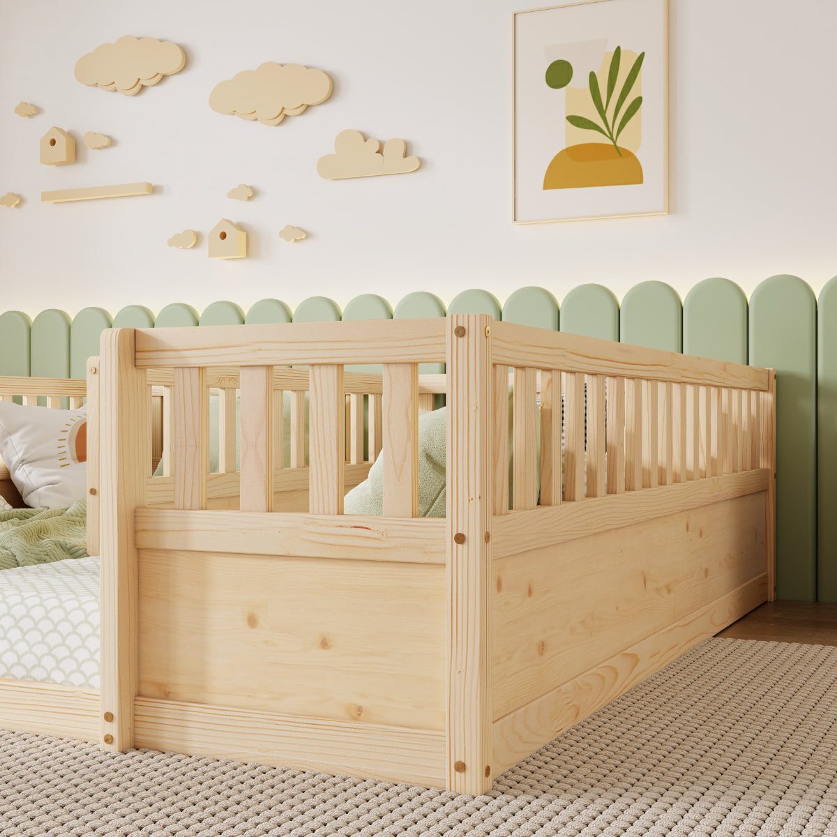 A light natural wood twin bed frame with a built-in guard rail, styled in a nursery setting with a green scalloped wall, wooden cloud decals, and a framed art print.