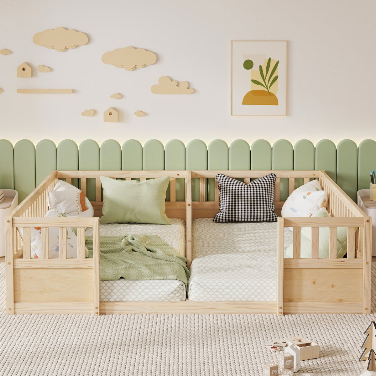 A light natural wood twin bed with built-in guard rails, styled in a children's bedroom with a green scalloped wall panel, wooden cloud decals, and a small plant print.