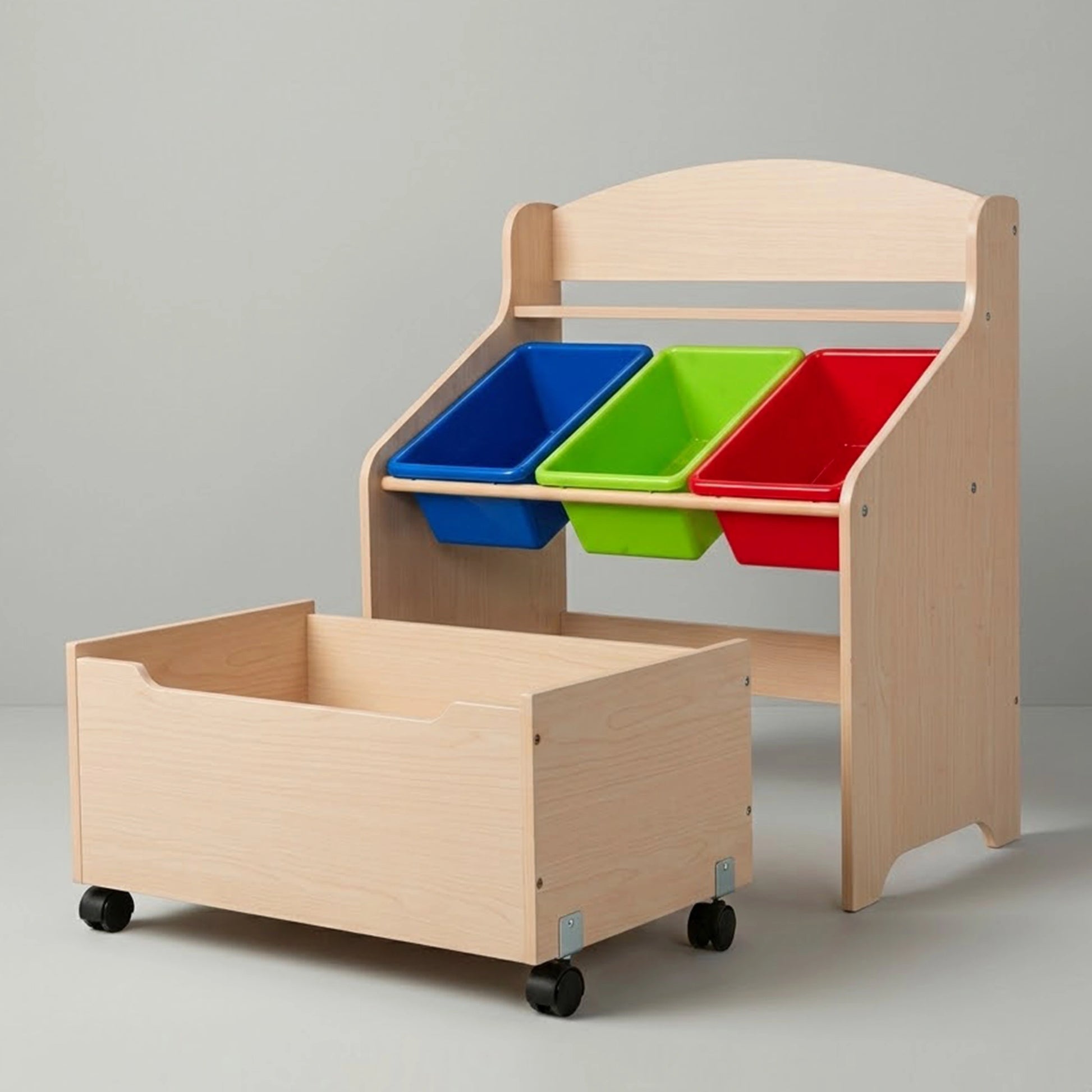 A studio shot of a light wood kids' toy storage organizer against a clean grey background. The spacious bottom rolling toy box is pulled out, demonstrating its mobility, while the top shelf securely holds three empty, colorful removable plastic bins in blue, green, and red.