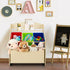 A light wood kids' toy storage organizer in a playful room setting. The unit features a top display shelf for art supplies, three removable colorful plastic bins (red, green, and blue) holding small toys, and a spacious bottom rolling wooden toy box equipped with casters, filled with plush animals.
