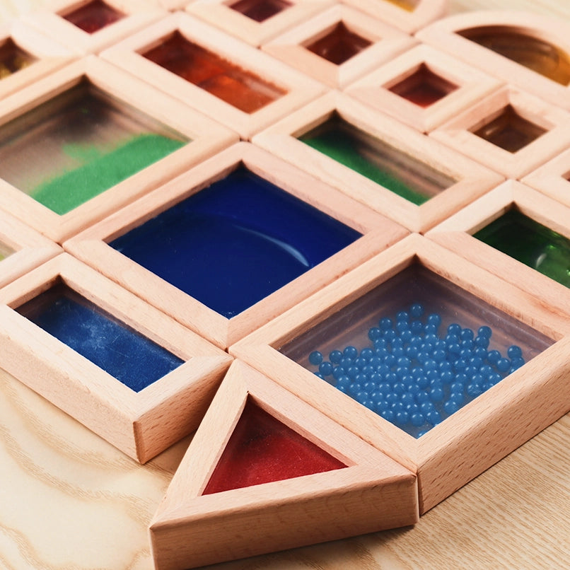 A semi-circle wooden sensory block filled with tiny red beads, showcasing texture and sound element.