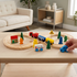 Child's hand pushing wooden train on track, close-up interactive play detail