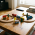 Top view of assembled wooden train track layout with colorful trains and scene accessories